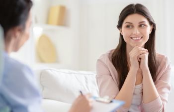 Smiling woman talking to a psychotherapist.